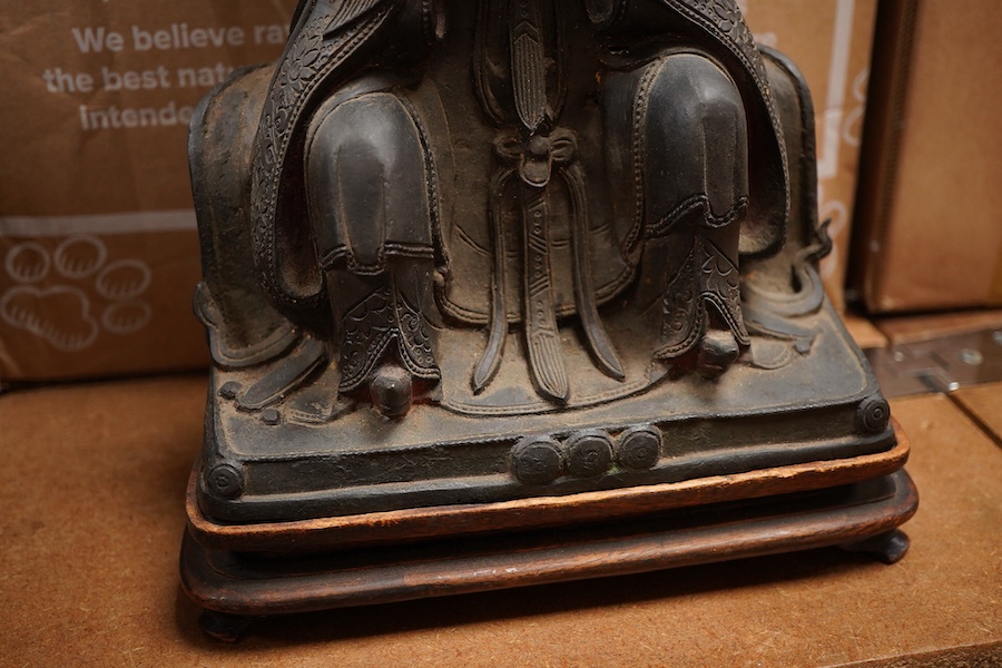 A Chinese late Ming bronze seated figure of Xi Wangmu, early 17th century (on stand). 34.5cm high not including stand.